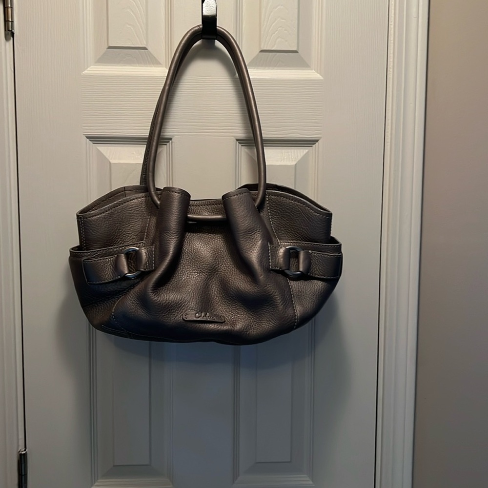 Cole Haan  handbag in pewter/gray with drawstring type straps.
